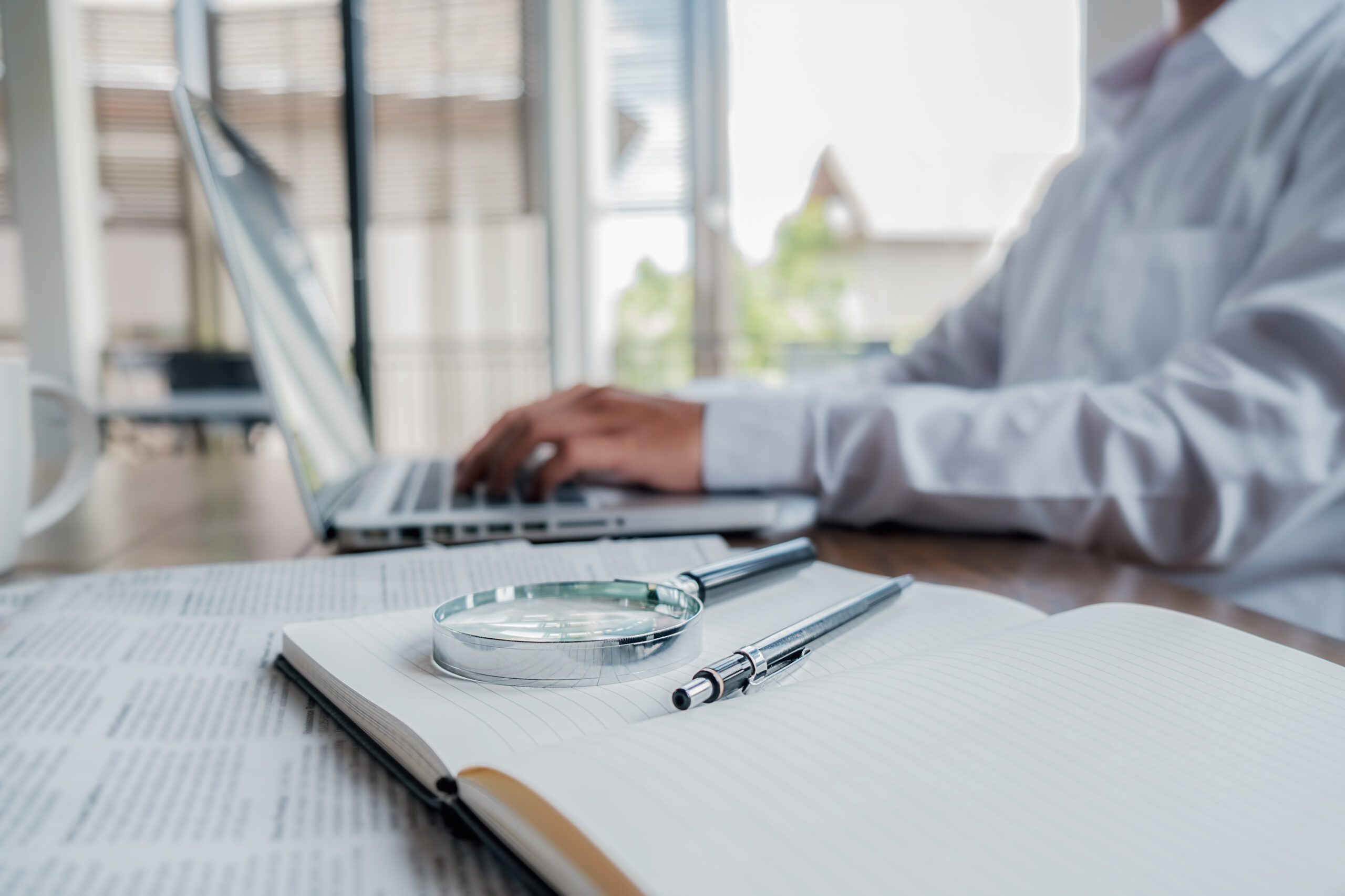 Young unemployed is searching for a job in the newspaper and lap